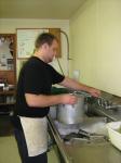 Brandon Harding, WHS grad, prepares to cook dinner at the Diamond C