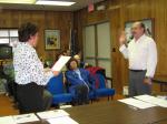 Borough clerk Christie Jamieson swears Don McConachie into office of borough mayor.