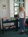 Librarian Kay Jabusch stands by a sample of summer reading books.